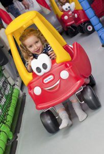Little girl in her car on the Toddler Town Kart Track at Kidabulous, Sunbury on Thames