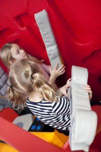 Little girls playing in ToddlerTown, early years indoor soft play area.