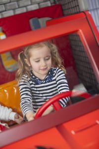 Little girl driving a car at the Toddler Town kart track