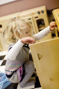 Little girl playing in Toddler Town Cafe