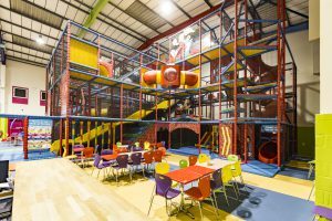 Seating areas next to giant playframe at Kidabulous